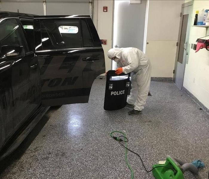 SERVPRO technician cleaning police shield