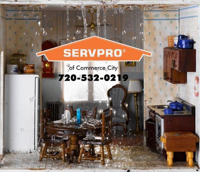 Water is pouring out of a ceiling and is flooding a kitchen.