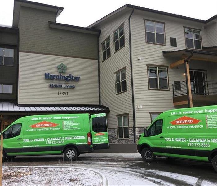 SERVPRO trucks out front of a hotel